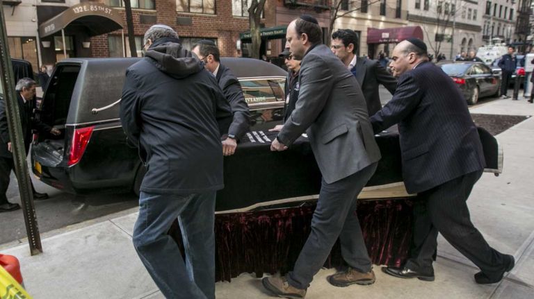 The body of David Wichs, who was killed Friday by a collapsing crane, is carried in a simple wooden casket outside the Congregation Kehilah Jeshurun in the Upper East Side on Feb. 7, 2016.