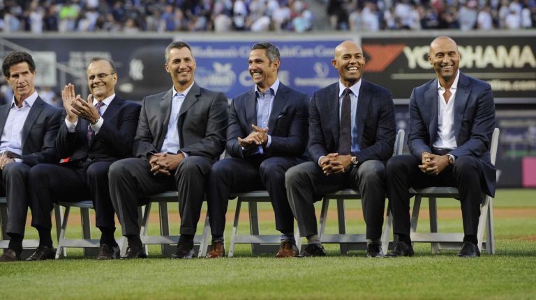 From left, former New York Yankees Paul O'Neill, manager Joe Torre, Andy Pettitte, Jorge Posada, Mariano Rivera and Derek Jeter react during a ceremony to honor Bernie Williams and retire his No. 51 before a game between the Yankees and the Texas Rangers at Yankee Stadium on Sunday, May 24, 2015.