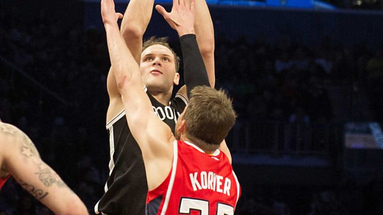 Brooklyn Nets' Bojan Bogdanovic shoots over Kyle Korver of the Atlanta Hawks in the fourth quarter during Game 3 of the Eastern Conference quarterfinals at Barclays Center on Saturday, April 25, 2015.