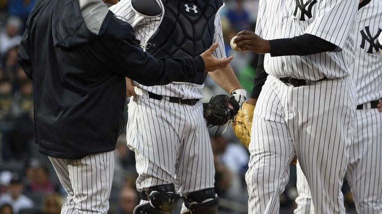 New York Yankees manager Joe Girardi takes the ball from New York Yankees starting pitcher CC Sabathia during the sixth inning against the New York Mets in a baseball game at Yankee Stadium on Saturday, April 25, 2015.