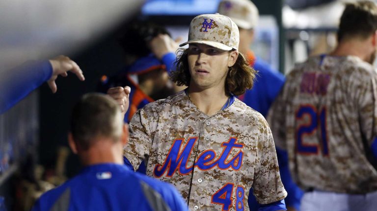 Jacob deGrom #48 of the New York Mets looks on from the dugout after the fourth inning against the Miami Marlins at Citi Field on Monday, Sept. 15, 2014 in the Queens Borough of New York City.