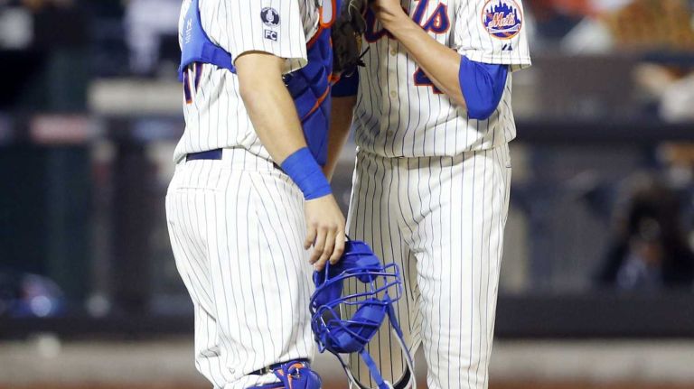 Jacob deGrom #48 of the New York Mets talks with teammate Travis d'Arnaud #15 of the New York Mets after surrendering a seventh inning double against the San Francisco Giants at Citi Field on Saturday, August 2, 2014 in the Queens Borough of New York City.