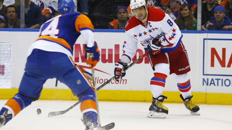 Alex Ovechkin #8 of the Washington Capitals looks to make a play in the second period as Calvin de Haan #44 of the New York Islanders defends during Game 3 of the Eastern Conference quarterfinals at Nassau Coliseum on Sunday, April 19, 2015.