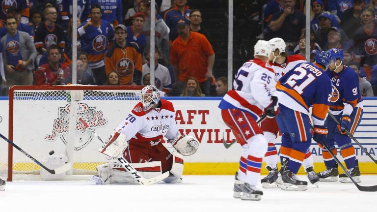Kyle Okposo #21 of the New York Islanders scores a second-period goal against Braden Holtby #70 of the Washington Capitals during Game 3 of the Eastern Conference quarterfinals at Nassau Coliseum on Sunday, April 19, 2015.