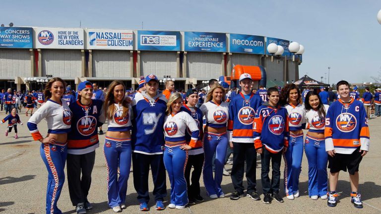New York Islanders ice girls and fans pose for photos before the Game 3 of the Eastern Conference quarterfinals against the Washington Capitals during the 2015 NHL Stanley Cup Playoffs at the Nassau Veterans Memorial Coliseum on April 19, 2015.