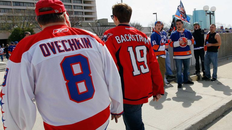 Washington Capitals fans are heckled by New York Islanders fans before Game 3 of the Eastern Conference quarterfinals during the 2015 NHL Stanley Cup Playoffs at the Nassau Veterans Memorial Coliseum on April 19, 2015.