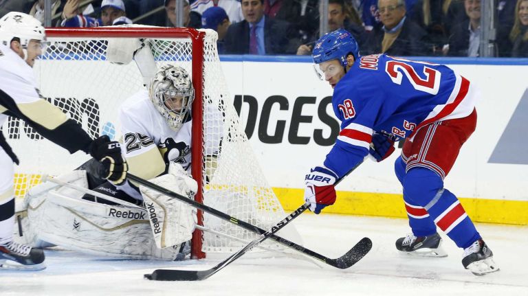 Marc-Andre Fleury of the Pittsburgh Penguins defends a scoring chance in the second period against Dominic Moore of the New York Rangers during Game 1 of the Eastern Conference quarterfinals at Madison Square Garden on Thursday, April 16, 2015.