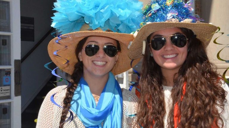 Wearing under-the-sea-themed bonnets, Nikki Knauer, then 16, left, of Sag Harbor, and Olivia LaManna, then 14, of Sag Harbor, march in Sag Harbor's 18th annual sidewalk Easter bonnet parade on Saturday, March 30, 2013.