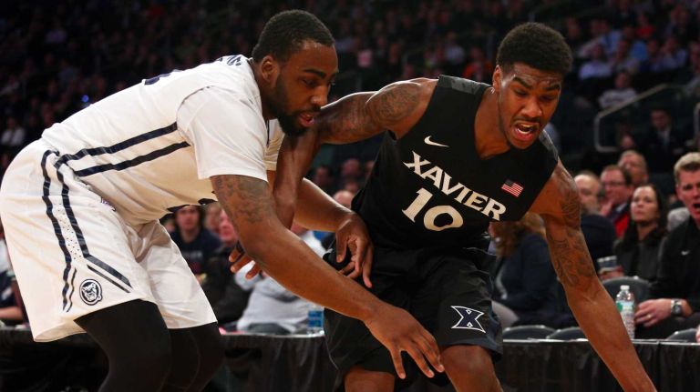 Xavier Musketeers guard Remy Abell saves the ball from going out of bounds in front of Butler Bulldogs forward Roosevelt Jones during the first half of a Big East Tournament game at Madison Square Garden on Thursday, March 12, 2015.