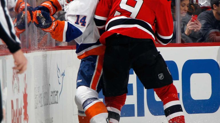 Thomas Hickey of the New York Islanders is checked by Martin Havlat of the New Jersey Devils during the second period at the Prudential Center on Jan. 9, 2015 in Newark, N.J.
