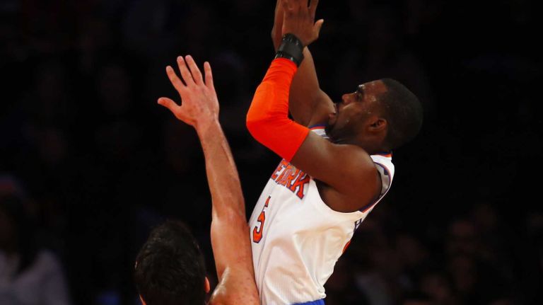 Tim Hardaway Jr. #5 of the New York Knicks takes a shot against Zaza Pachulia #27 of the Milwaukee Bucks at Madison Square Garden on Sunday, Jan. 4, 2015 in New York City.