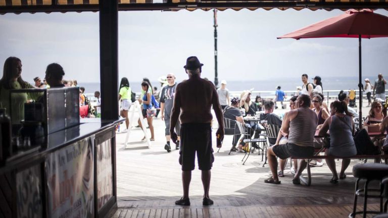 A man stands with a beer at Ruby's Bar and Grill in Coney Island on Wednesday, Aug. 6, 2014. The boardwalk staple celebrated its 80th birthday that Saturday.