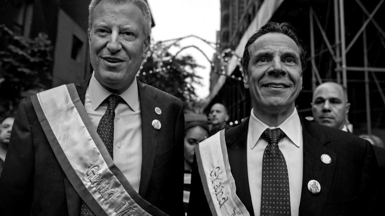 Mayor Bill DeBlasio, left, walks with Gov. Andrew M. Cuomo as they attend the 88th annual Feast of San Gennaro parade in Manhattan's Little Italy neighborhood on Saturday, Sept. 13, 2014.