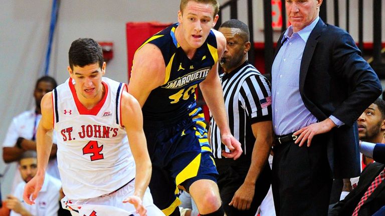 Federico Mussini leads a break, getting around Marquette center Luke Fischer, as St. John's coach Chris Mullin, right, looks on during Marquette's 78-73 victory Sunday at Carnesecca Arena.
