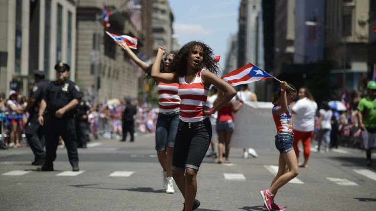 Participants march and dance during the 57th annual National Puerto Rican Day Parade in Manhattan on Sunday, June 8, 2014.