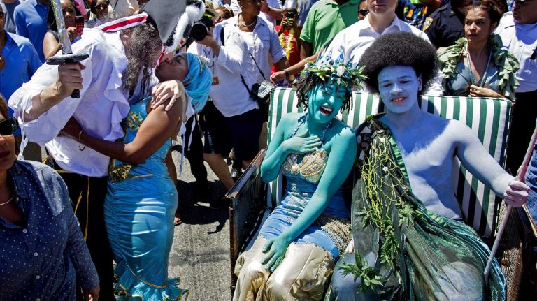 Chirlane McCray, and Dante de Blasio, posing as King Neptune and Queen Mermaid, react as their parents, Chirlane de Blaiso and father, New York Mayor Bill de Blasio, kiss as they march in the annual Coney Island Mermaid Parade ,June 21, 2014.