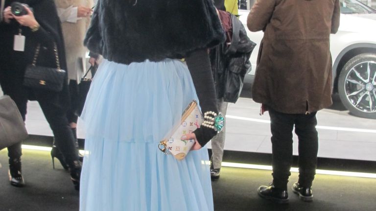 Anna Talyzin, of Moscow, tops off her ultra-feminine skirt and fur capelet with a striking hat at Lincoln Center during New York Fashion Week.