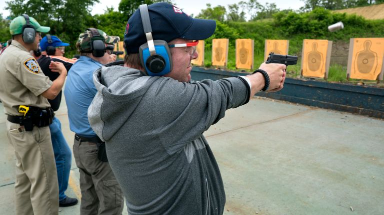 NYPD police officer Paul Sulzbach, center, joins other officers at Rodman's neck gun range in the Bronx on May 30, 2018, as they train on 9mm firearms.