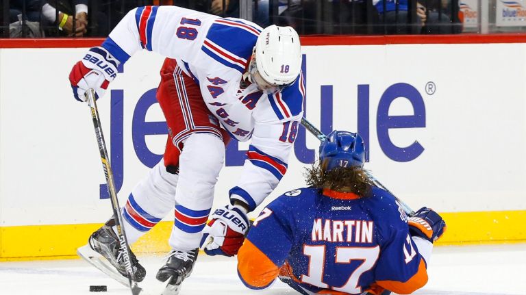 
Marc Staal #18 of the New York Rangers and Matt Martin #17 of the New York Islanders collide in the third period of a game at Barclays Center on Wednesday, Dec. 30, 2015.