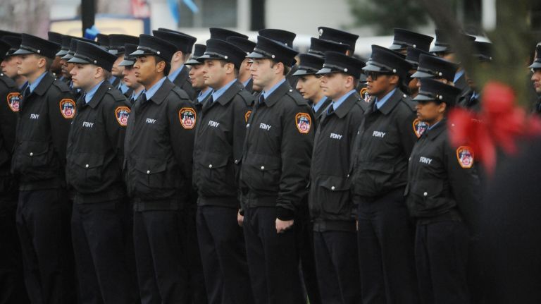 Fireman stand at attention as the family of William N. Tolley of Ladder Company 135 enters the Chapey and Sons Funeral Home in Bethpage on Wednesday, April 26, 2017.