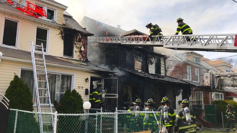 FDNY firefighters work at a house fire at 112th Avenue and 208th Street in Queens Village on Sunday, April 23, 2017.