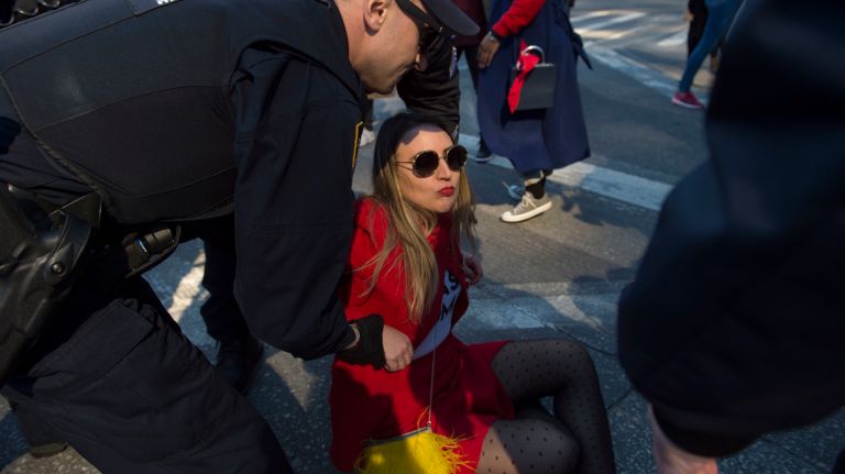 A woman is arrested in Manhattan's Columbus Circle during the A Day Without a Woman rally for International Women's Day on March 8, 2017.