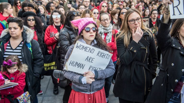 A woman holds a protest sign during the A Day Without a Woman rally in Manhattan on International Women's Day on March 8, 2017.