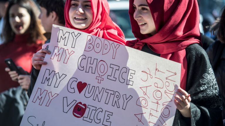 Two women hold a protest sign during the A Day Without a Woman rally in Manhattan on March 8, 2017.