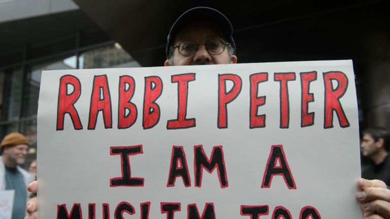 A participant holds a sign at the I Am A Muslim Too rally in Times Square on Feb. 19, 2017. 
