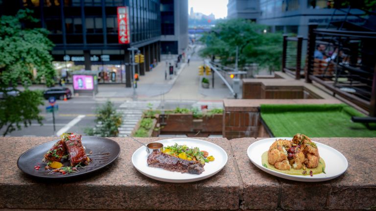 Wall Street Grill welcomes customers to the 'family' for Rosh Hashanah dinner 2 Left to right, lamb rib bites with pomegranate molasses, tangerine, ras el hanout, a spice mixture; teriyaki glazed Brisket with roasted vegetables and roasted cauliflower with dried craisins, pistachio, pomegranate, and a saffron tahini emulsion at the Wall Street Grill, who is offering Kosher rooftop dining for Rosh Hashanah.