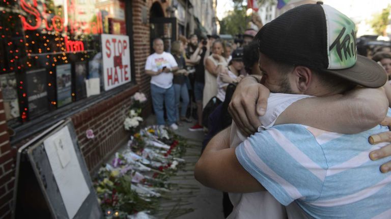 People gather at The Stonewall Inn in Manhattan on Sunday, June 12, 2016, at a vigil for Orlando, Fla., shooting victims. A gunman armed with an assault rifle and handgun killed 49 people and wounded 53 at Pulse, a gay nightclub in Orlando, in what officials termed the worst mass shooting in U.S. history.