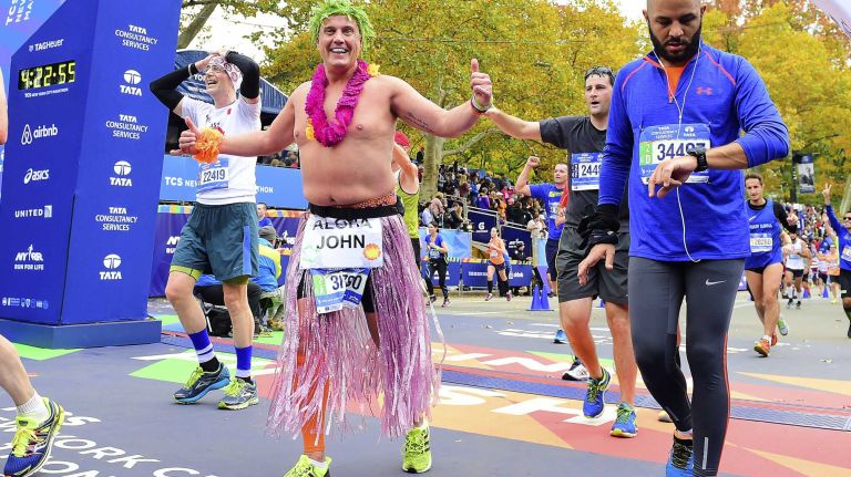 Runners cross the finish line of the New York City Marathon in Manhattan on Sunday, Nov. 1, 2015.