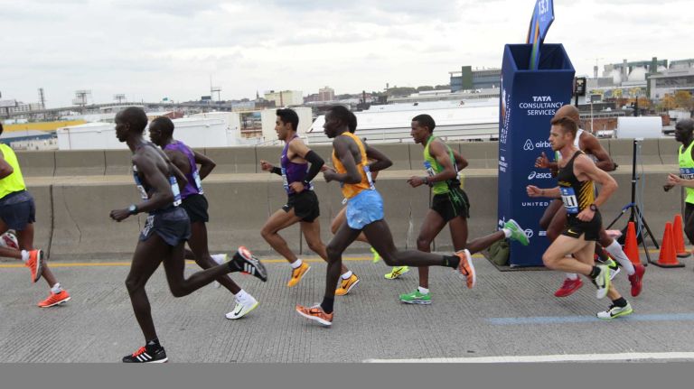New York City Marathon male participants run along the race route in Brooklyn on Nov. 1, 2015.