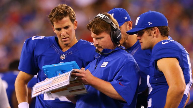 Giants offensive coordinator Ben McAdoo, center, has been credited with helping improve quarterback Eli Manning's completion percentage.