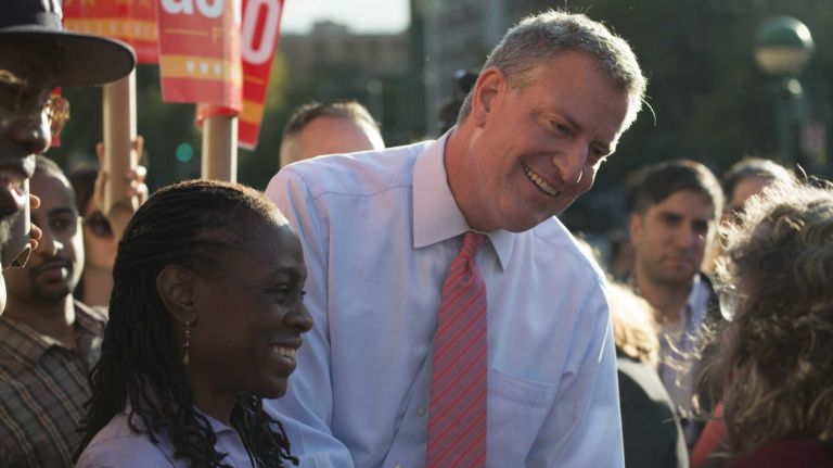 Democratic mayoral nominee Bill de Blasio and his wife, Chirlane McCray, greet supporters at the intersection of 116th Street and Lenox Avenue in Harlem. (Sept. 26, 2013)