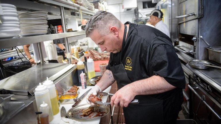 Wall Street Grill welcomes customers to the 'family' for Rosh Hashanah dinner 3 Executive Chef Joseph "Joey" Paulino, who was raised in Franklin Square, Long Island, in the kitchen at the Wall Street Grill in Manhattan.