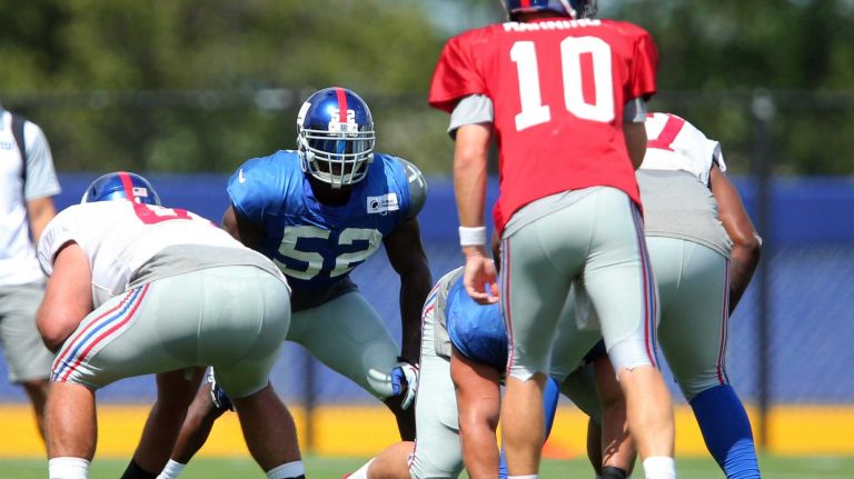 New York Giants linebacker Jon Beason lines up opposite quarterback Eli Manning during training camp at the Quest Diagnostics Training Center in East Rutherford, N.J., on Wednesday, Aug. 5, 2015.
