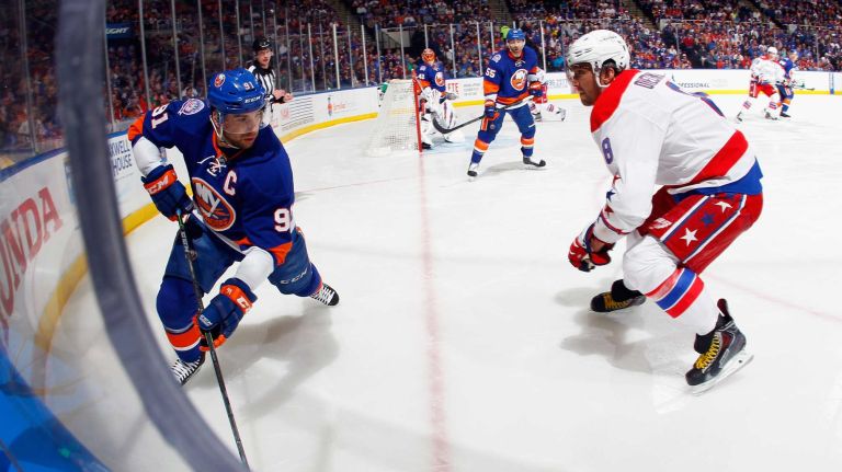 Alex Ovechkin #8 of the Washington Capitals lines up John Tavares #91 of the New York Islanders for a hit during the first period in Game 3 of the Eastern Conference quarterfinals during the 2015 NHL Stanley Cup Playoffs at the Nassau Veterans Memorial Coliseum on April 19, 2015.
