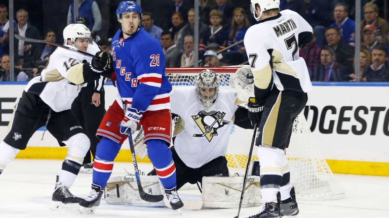 Marc-Andre Fleury of the Pittsburgh Penguins makes a glove save in the second period as teammates Ben Lovejoy and Paul Martin defend against Chris Kreider of the New York Rangers during Game 1 of the Eastern Conference Quarterfinals at Madison Square Garden on Thursday, April 16, 2015.