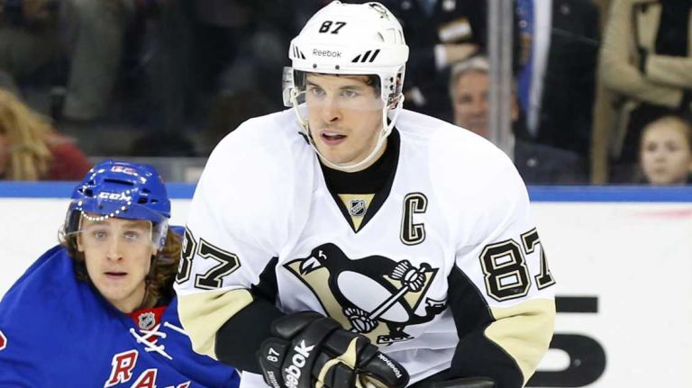 Sidney Crosby of the Pittsburgh Penguins skates with the puck in the third period against Carl Hagelin of the New York Rangers during Game 1 of the Eastern Conference Quarterfinals at Madison Square Garden on Thursday, April 16, 2015.