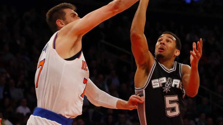 Andrea Bargnani of the New York Knicks tries to defend a shot in the first half against Cory Joseph of the San Antonio Spurs at Madison Square Garden on Tuesday, March 17, 2015.