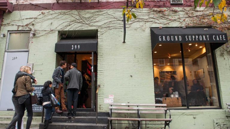 Ground Support Cafe, on West Broadway, is a busy coffee shop where patrons come to sample the many coffees, teas, and sandwiches that they offer.