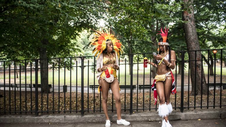 Costumed dancers get ready to march in the West Indian Day Parade along Eastern Parkway in Brooklyn on Monday, Sept. 5, 2016.