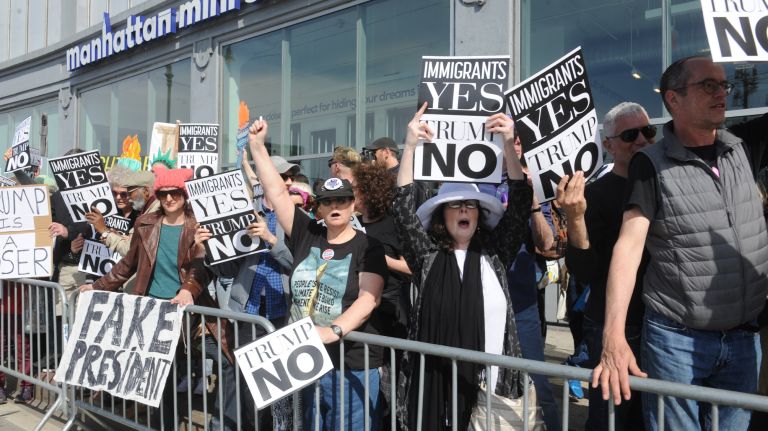 Protesters against President Donald Trump gather across the street from the Intrepid Sea, Air & Space Museum in Manhattan, awaiting his arrival on Thursday, May 4, 2017. 