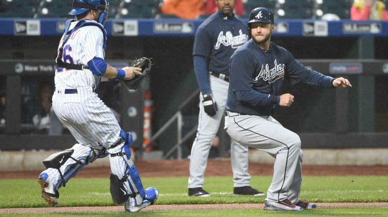 Mets vs. Braves 22 New York Mets catcher Kevin Plawecki runs to tag out Atlanta Braves catcher A.J. Pierzynski during the second inning of an MLB baseball game at Citi Field on Tuesday, May 3, 2016.