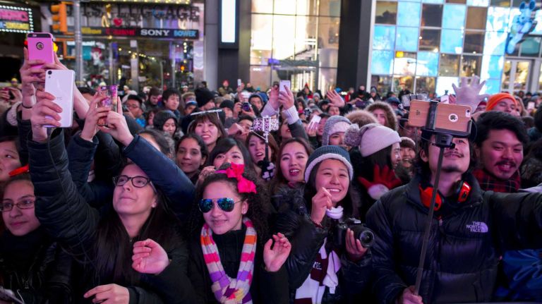 New Year's Eve in NYC 2015 to 2016: Pictures of the ball drop in Times Square and more 46 People celebrate New Year's Eve while the performers rehearse in the evening in Times Square in Manhattan, on Dec. 31, 2015.