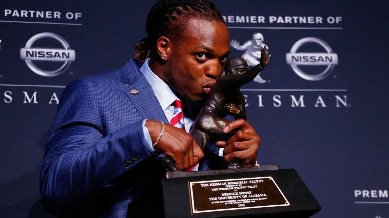 Running back Derrick Henry of the Alabama Crimson Tide kisses the Heisman Trophy during a press conference after being named the 81st Heisman Memorial Trophy Award winner during the 2015 Heisman Trophy Presentation at the Marriott Marquis on December 12, 2015 in New York City.
