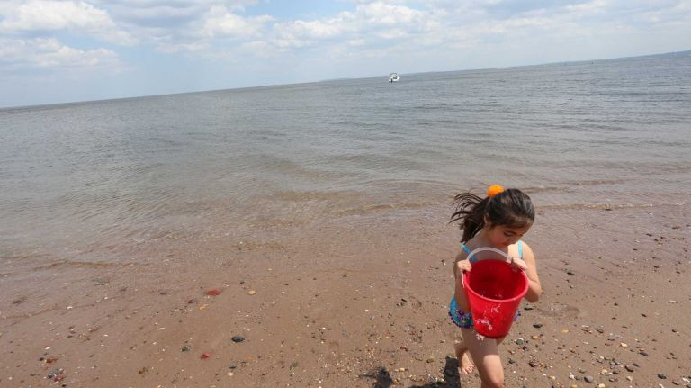 Julia Parga, 5, plays on the beach in Wolfe's Pond Park in Prince's Bay, Staten Island, Friday, May 22, 2015.