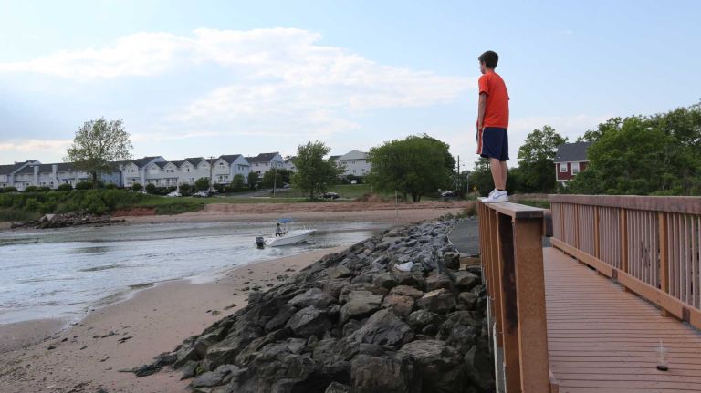 Alex Krisulas looks out on the bay from a bridge in Lemon Creek Park in Prince's Bay, Staten Island, Friday, May 22, 2015.