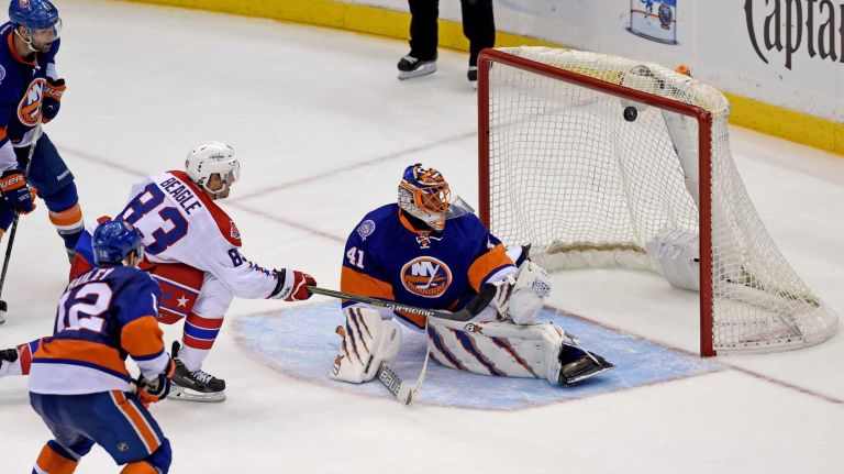Eastern Conference quarterfinals Game 6: Islanders vs. Capitals 81 The puck gets past New York Islanders goalie Jaroslav Halak, hits the cross bar and does not go in the net in the third period during Game 6 of the Eastern Conference quarterfinals against the Washington Capitals at Nassau Coliseum on Saturday, April 25, 2015.